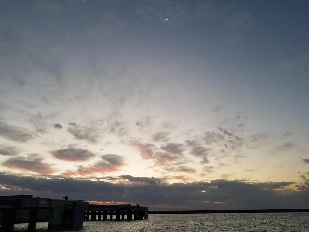 Sunset in Perth, West Australia. 

I'm on night shif here and snapped this picture a few hours ago.

You can see the moon in the top center of the image and if you zoom in on the moon there's a small dot of light just below it and off to the left. That my friends is Venus! 